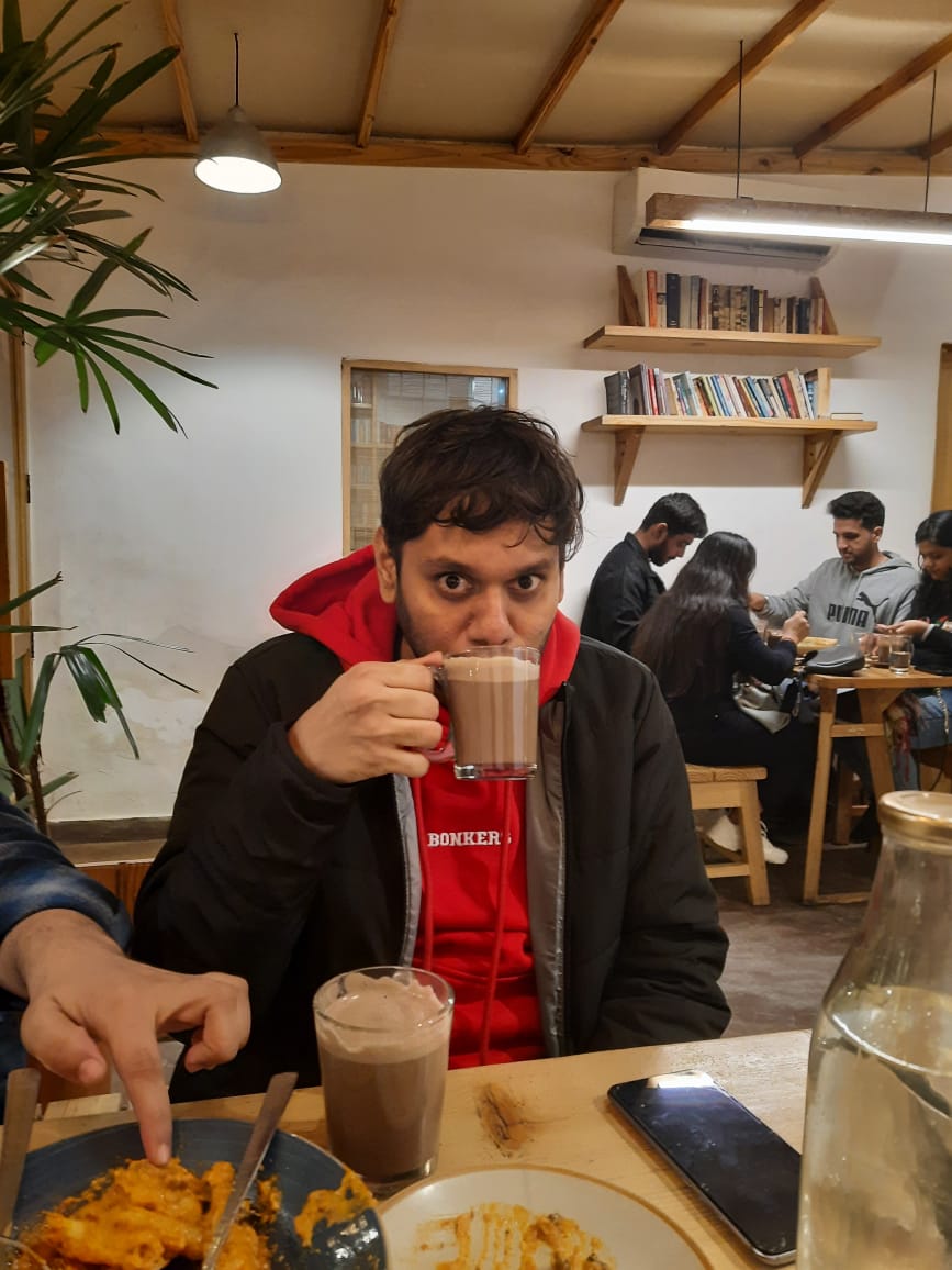 Abhinandan drinking coffee at a cafe