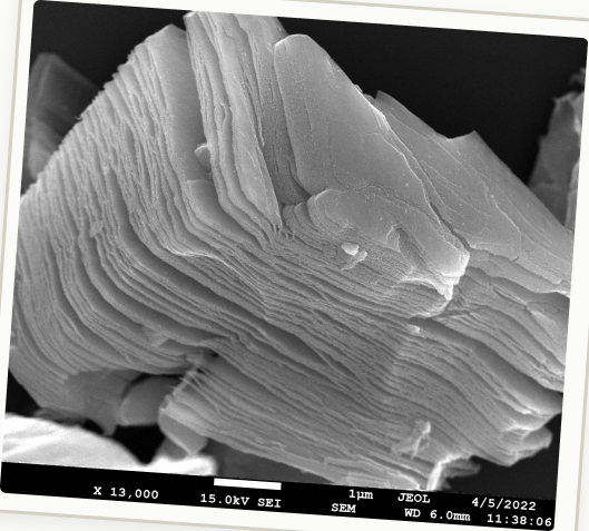 Scanning electron microscope image of a layered crystal at 13,000x magnification